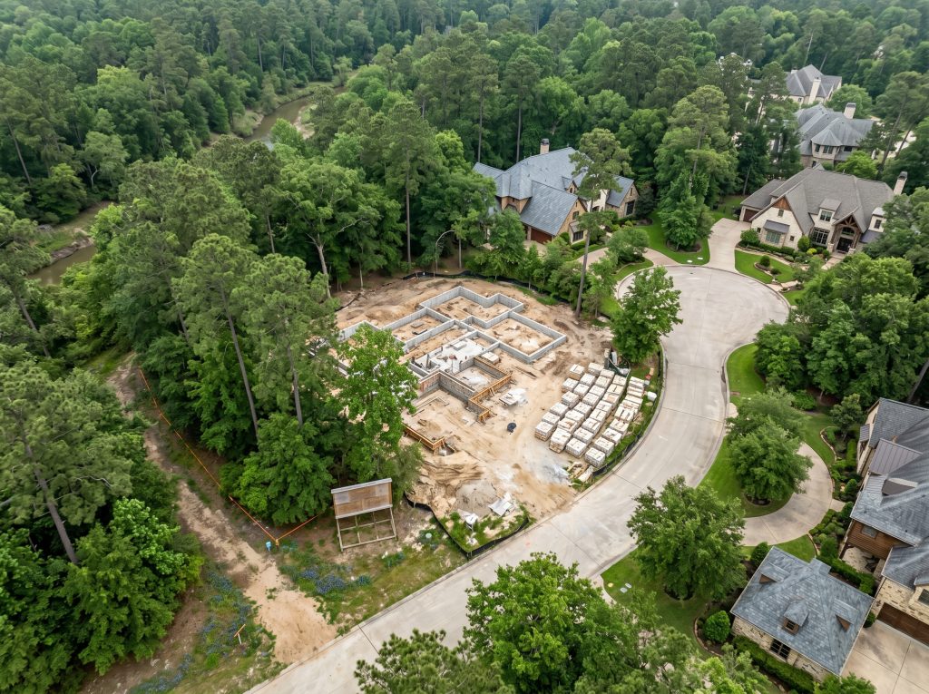 Aerial view of a custom home lot in The Woodlands TX — Carlton Woods village pine canopy and architecturally distinct neighbors.